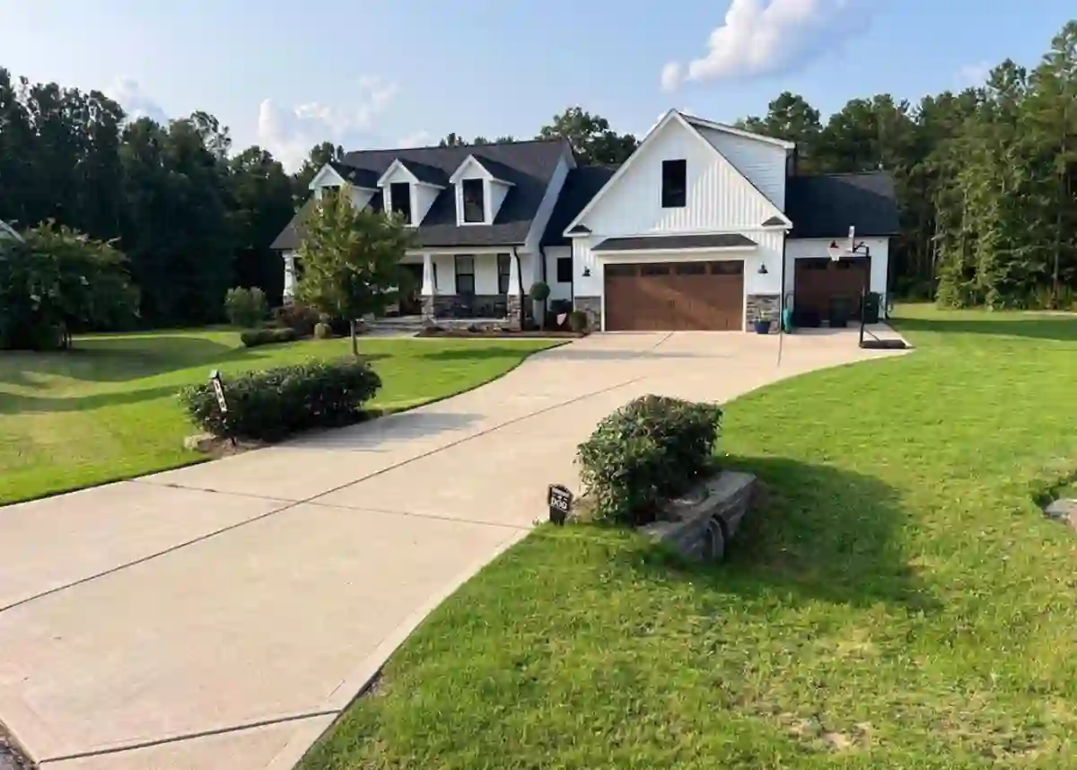 Freshly mowed and striped lawn at a white farmhouse home in Johnston County